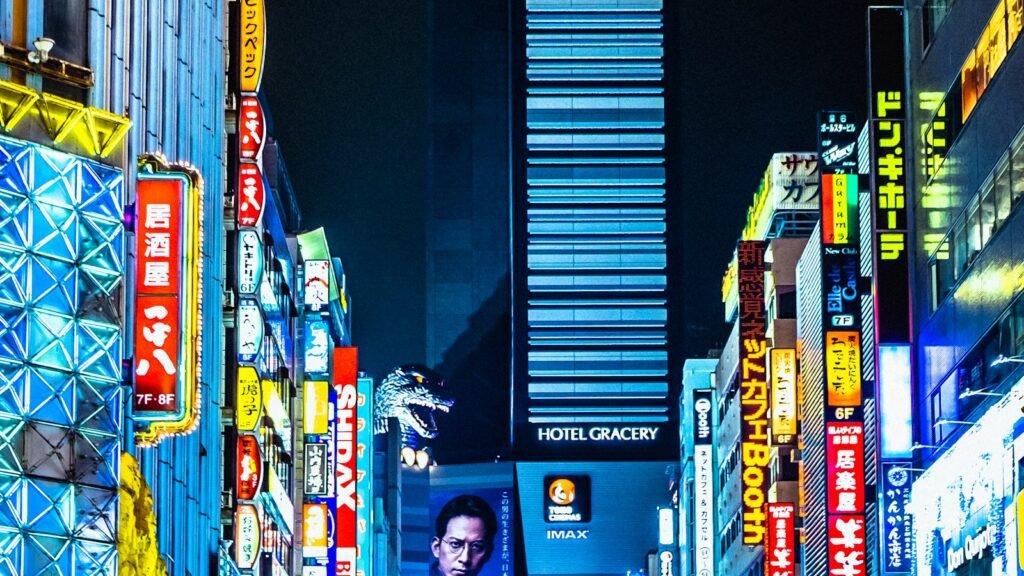 A narrow street in Shinjuku, Tokyo, lined with neon signs at night